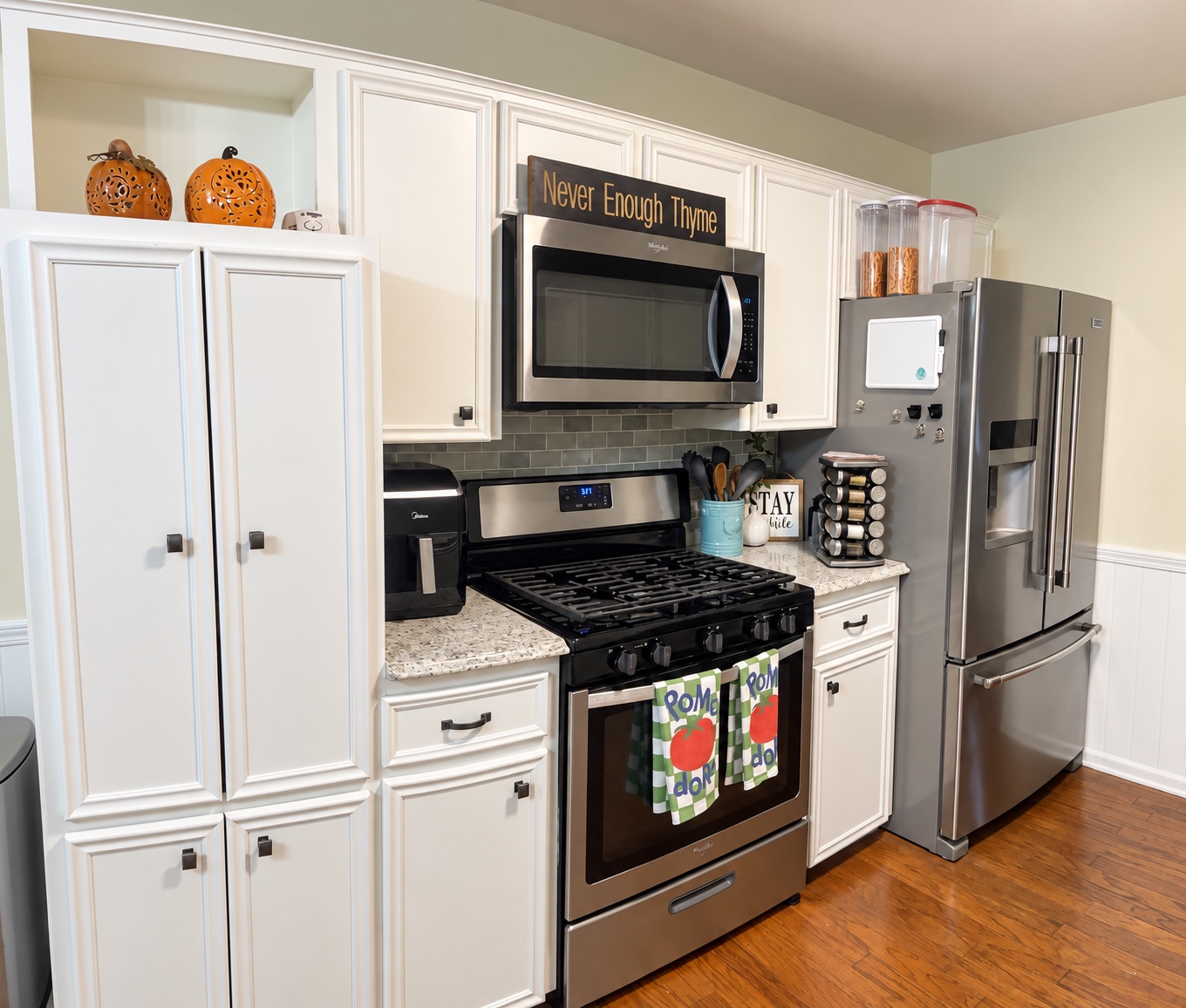 Bright kitchen with white cabinetry, stainless steel appliances, and a gas range